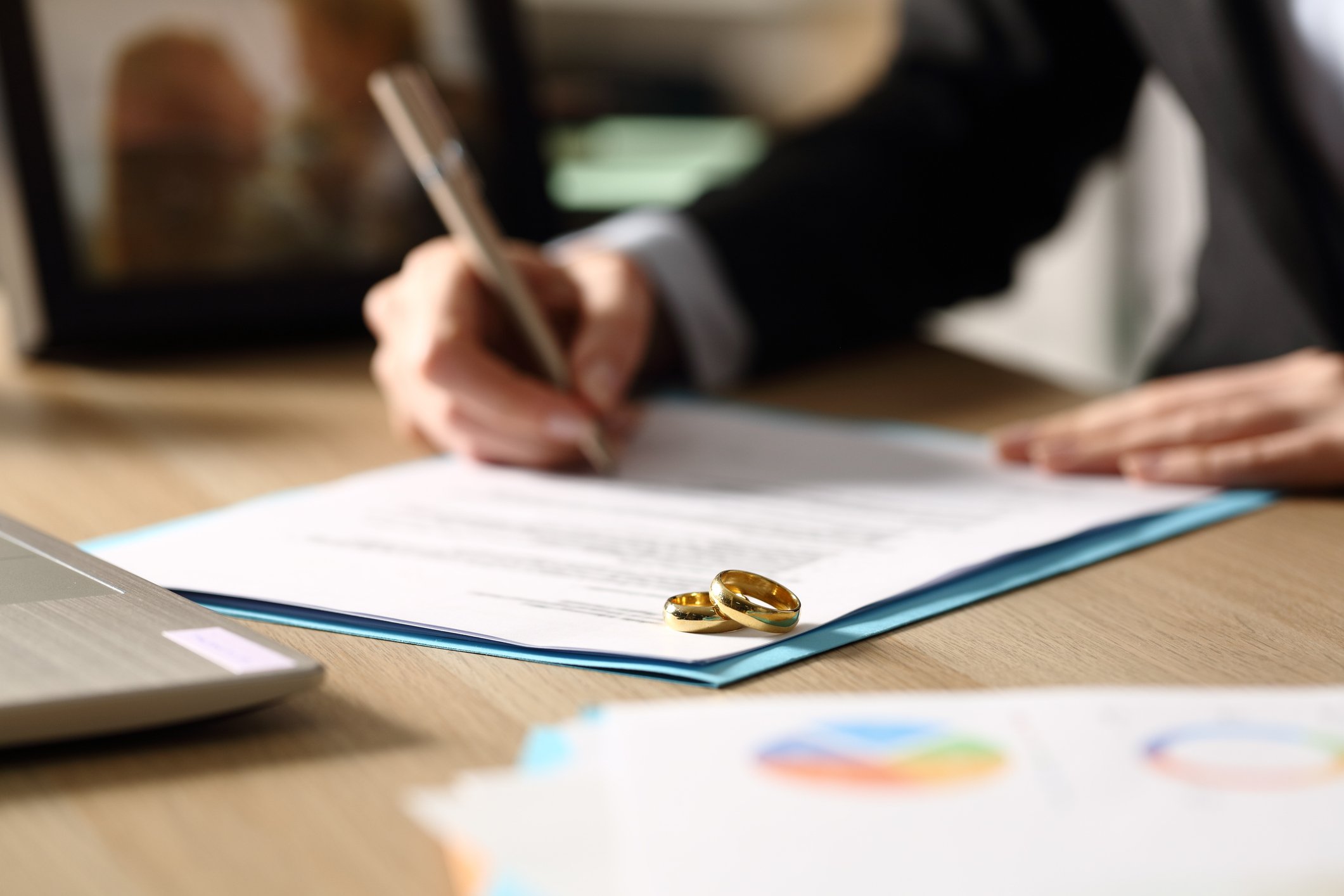 Freelance hands signs divorce papers at night divorce solicitors in taunton and somerset